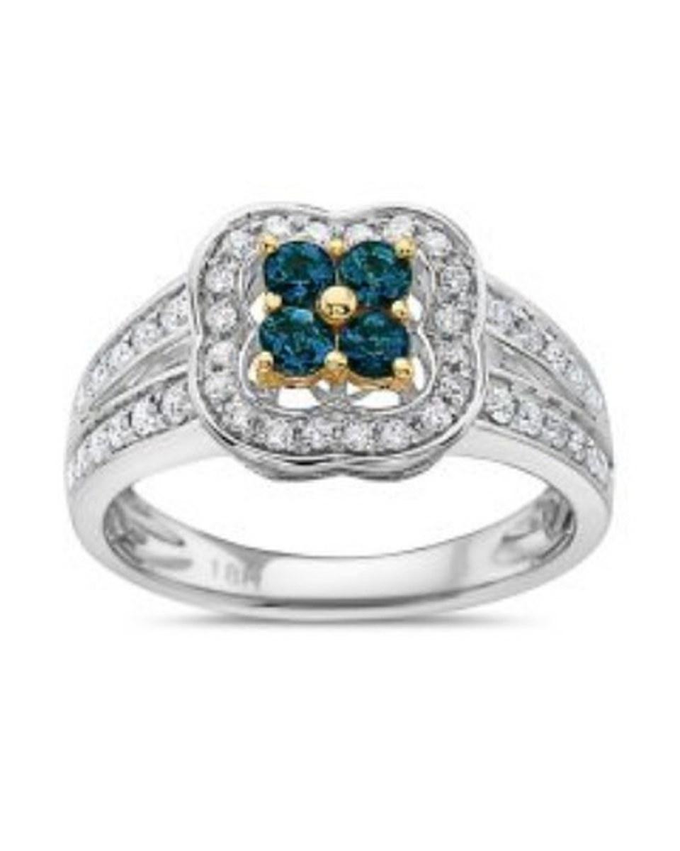 The TruAmore Radiant EXOTIC Lagoon Ring: four teal stones in a gold flower, framed by small clear stones on a white-metal band.