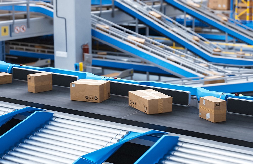 Packages moving along a conveyor belt. Motion control requires designers to look at the entire system, says Kollmorgen.