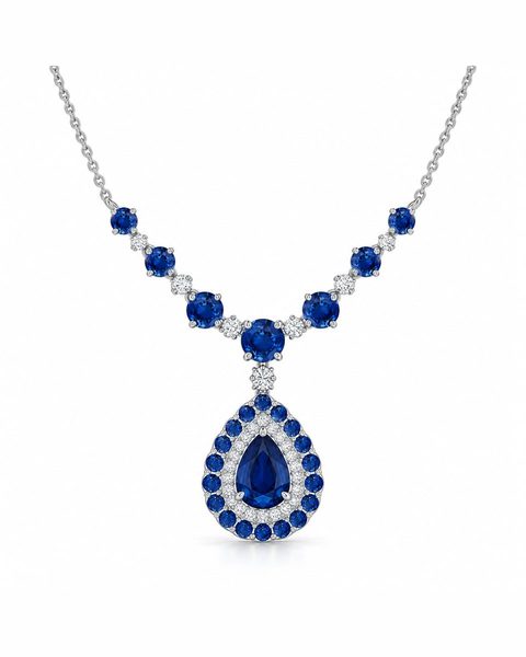 A blue teardrop pendant in a double halo on a necklace of small blue stones.