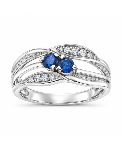 Twin blue stones in a flowing white-metal crossover ring.