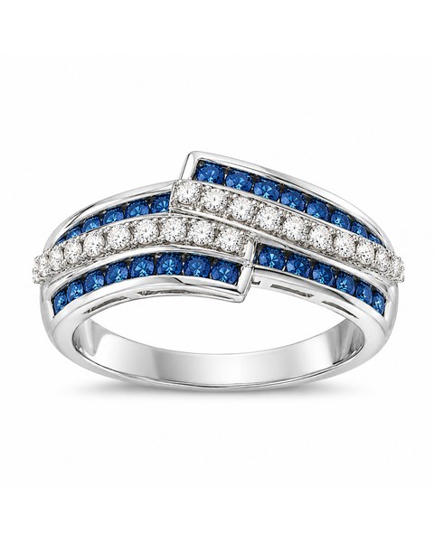 Overlapping white-metal bands set with rows of blue and clear stones.